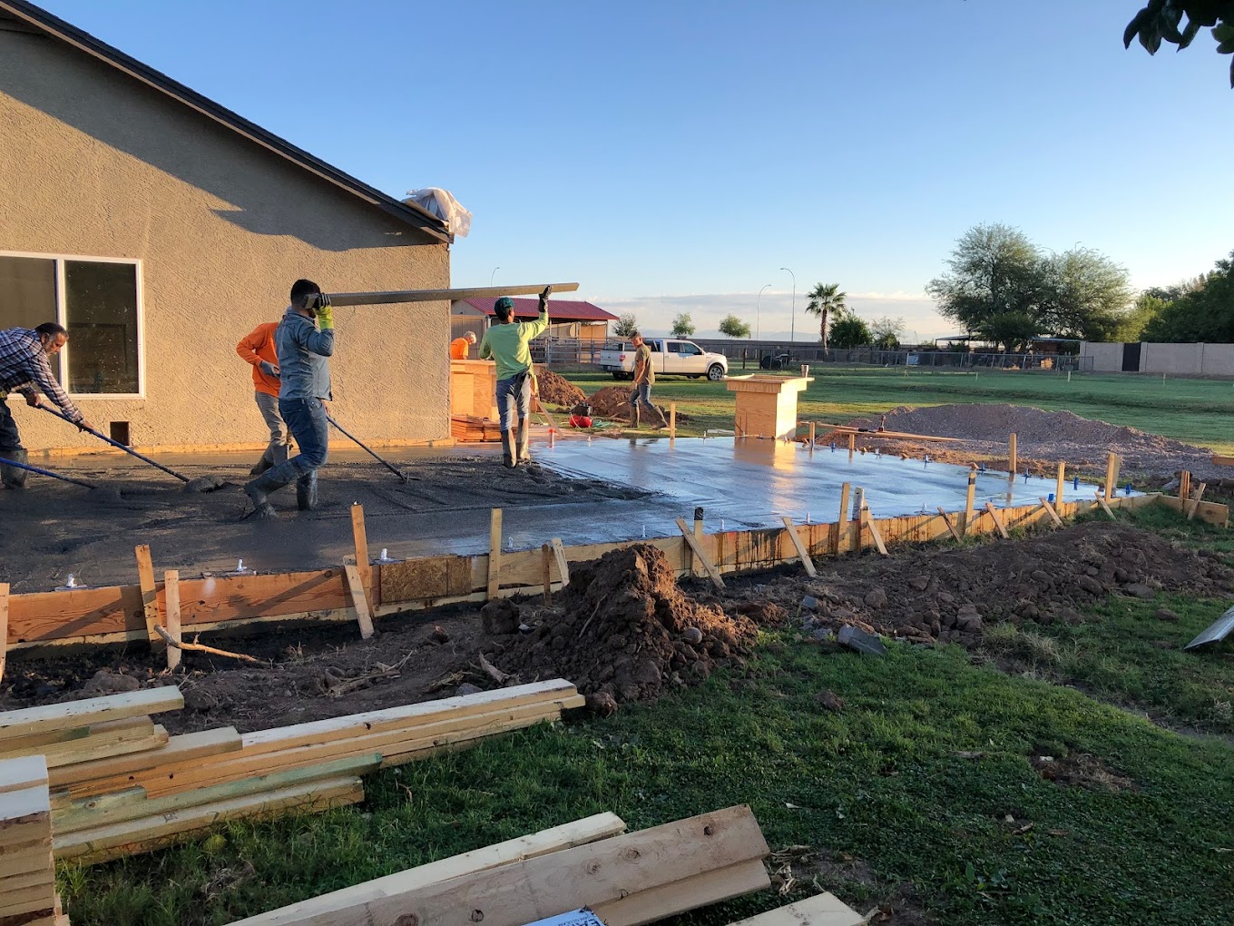 Workers installing new concrete foundation.