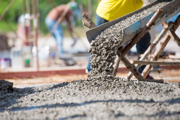 Worker pouring concrete for a concrete foundation in East Valley, AZ
